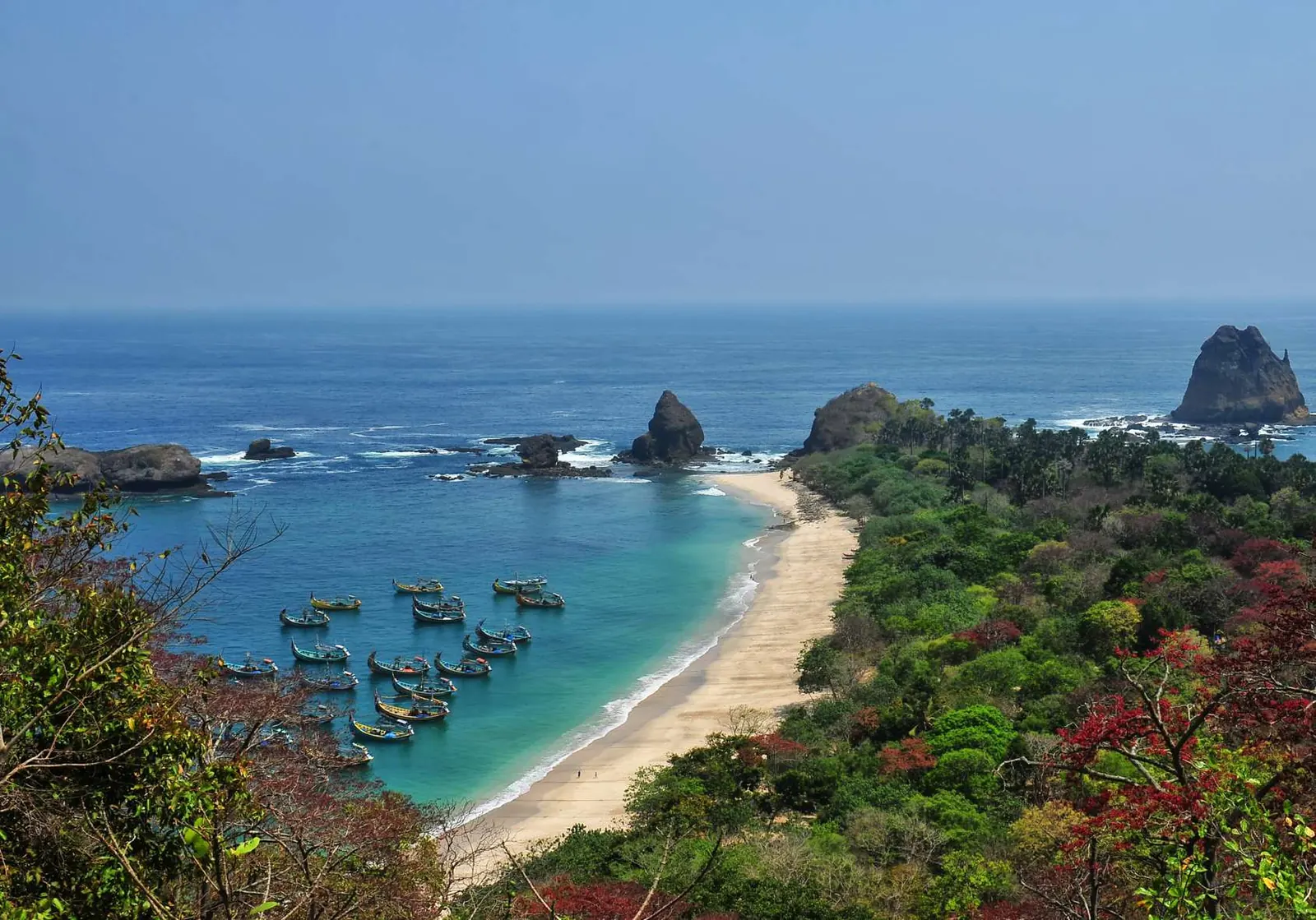 A sandy bay with fishing boats